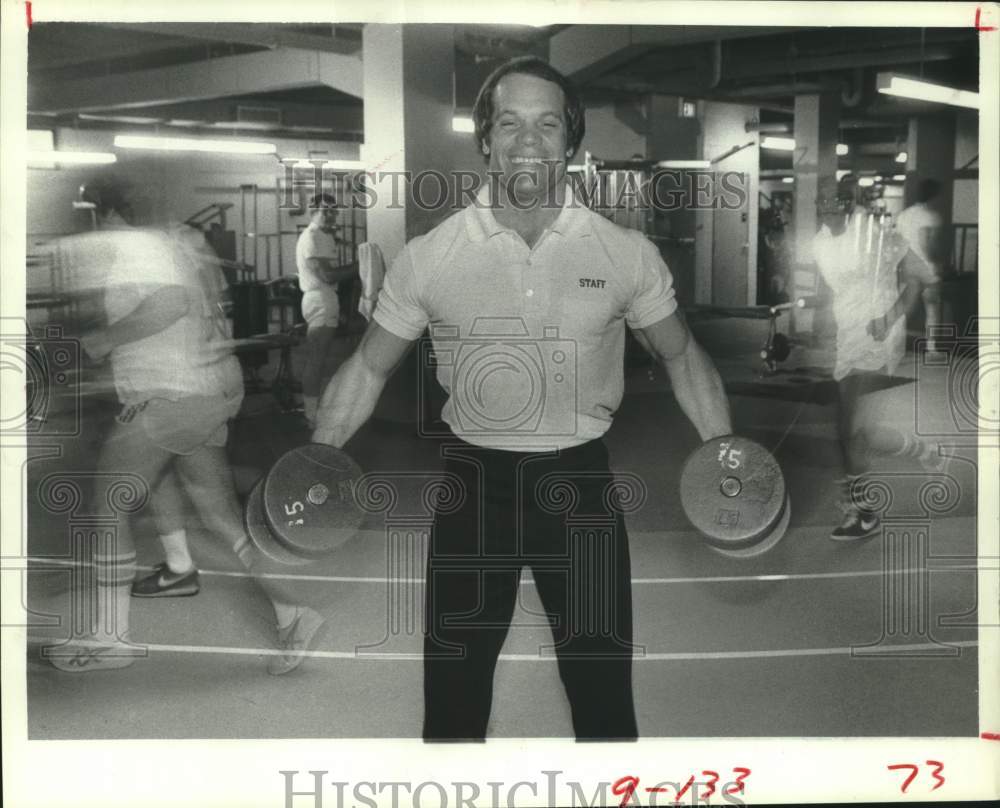 1983 Houston YMCA&#39;s Terry Daughtery lifts dumbbells - Historic Images