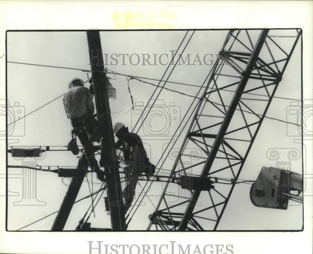 1987 Utility linemen work at 8400 North Freeway in Houston, Texas - Historic Images