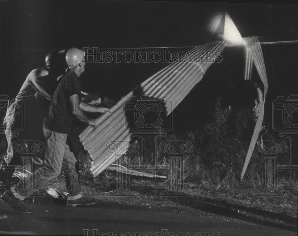 1964 Utility men remove tin from downed power line in Texas - Historic Images