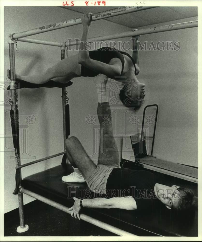 1983 Press Photo Bryan Peters, Abby Cuevas on the rack-Houston Ballet Academy - Historic Images