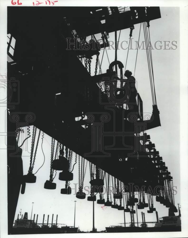 1980 Tenneco Inc. employee operates crane at Shipbuilding subsidiary - Historic Images