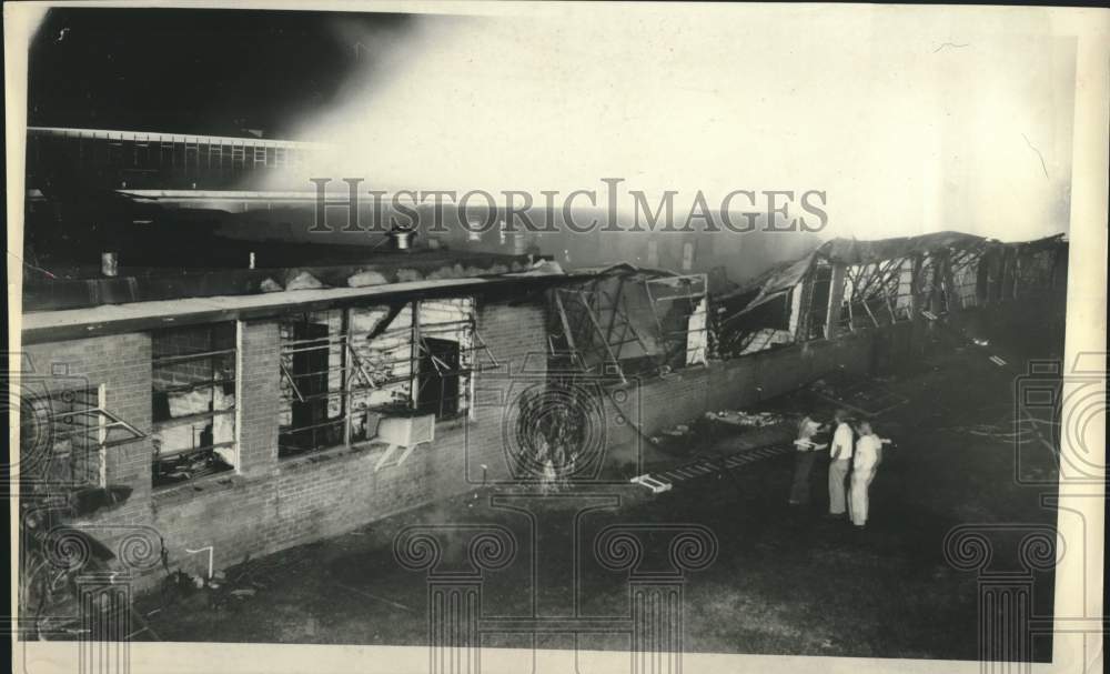 1965 Small group stands outside building gutted by fire - Houston-Historic Images