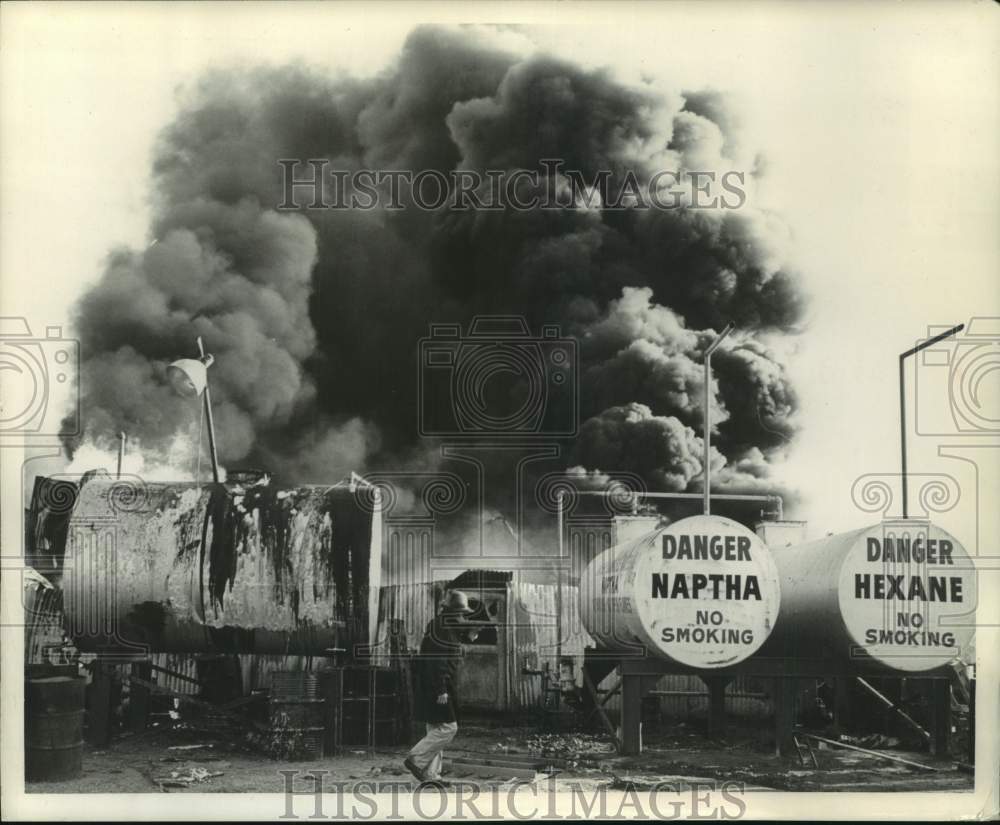 1965 Press Photo Individual Walks Near Rubber Products Plant Fire, McHard Rd, TX - Historic Images