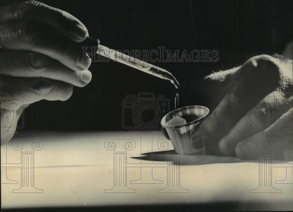 1962 Polio vaccine - two drops of vaccine onto a lump of sugar-Historic Images