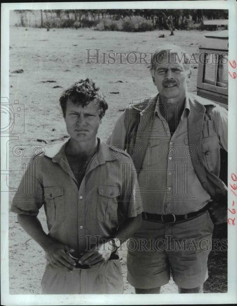 1984 Press Photo John Savage and Charlton Heston in &quot;Nairobi Affair&quot; - Historic Images