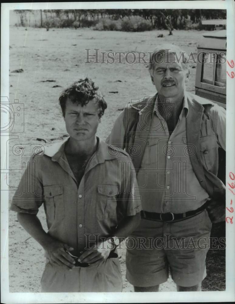 1984 Press Photo John Savage and Charlton Heston in "Nairobi Affair" - Historic Images