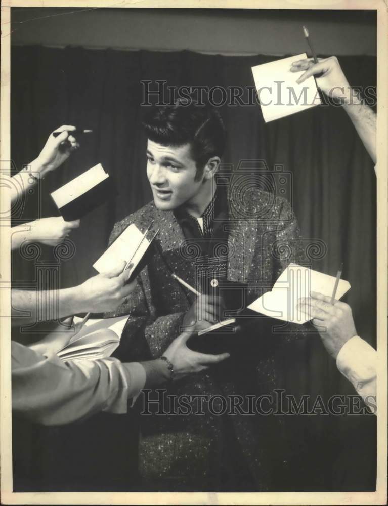 1957 Press Photo Tommy Sands signing autographs - hcx51446- Historic Images