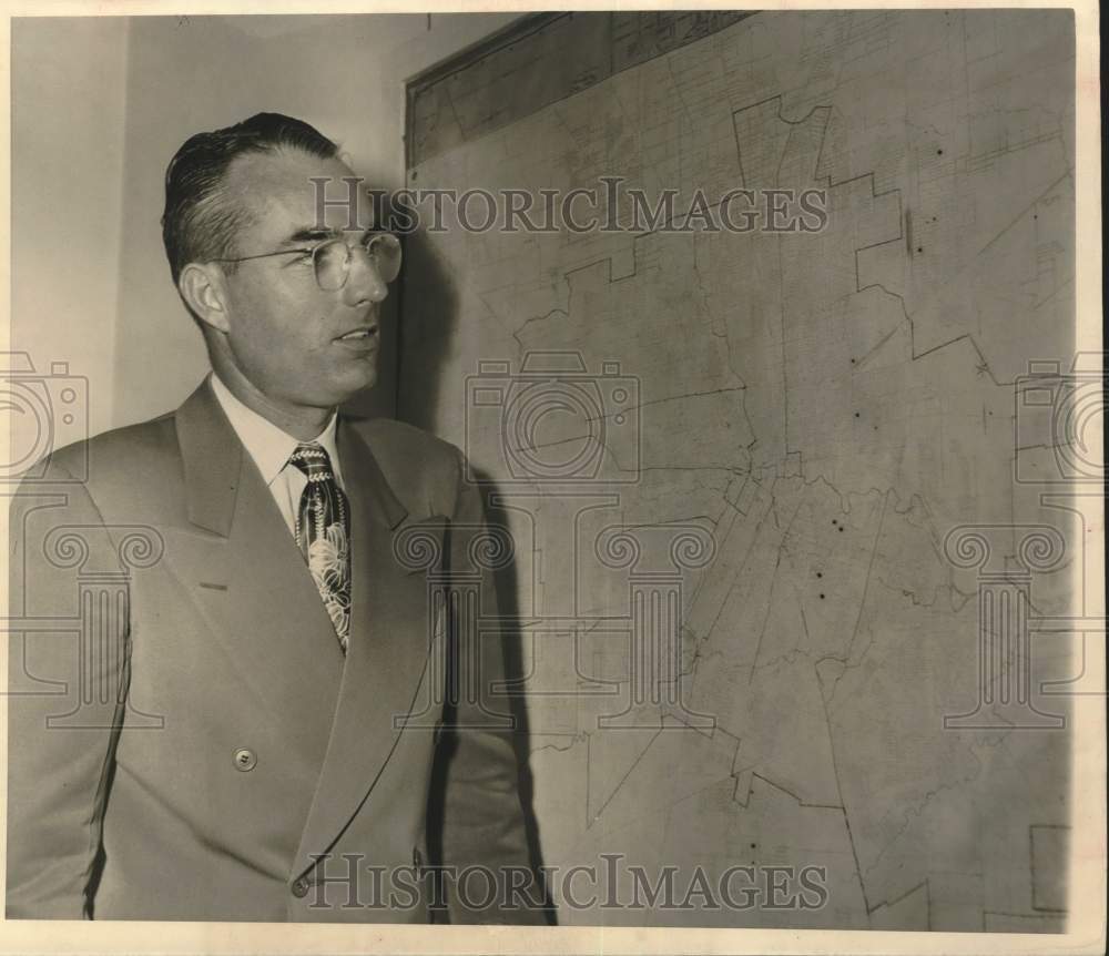 1951 Press Photo Allen C. Love looks at map on wall - hcx51811- Historic Images