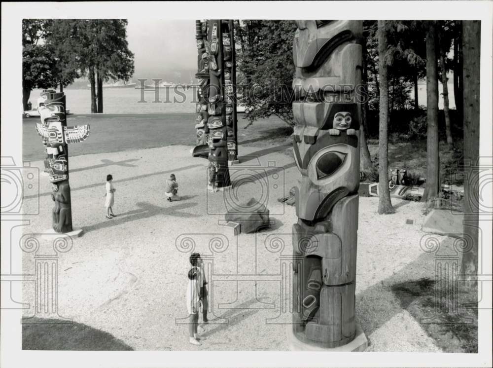 Press Photo Kids Look at Totem Poles at Stanley Park, Vancouver, Canada - Historic Images