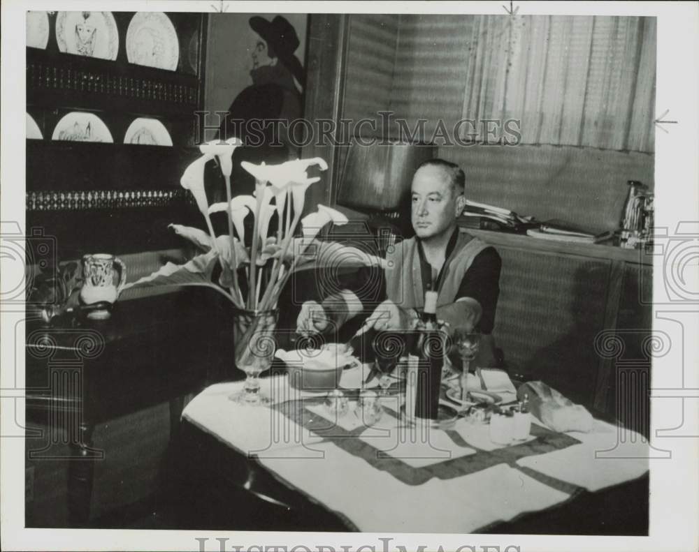 1958 Press Photo Artist Jean Negulesce, shown at table. - hpa82732- Historic Images