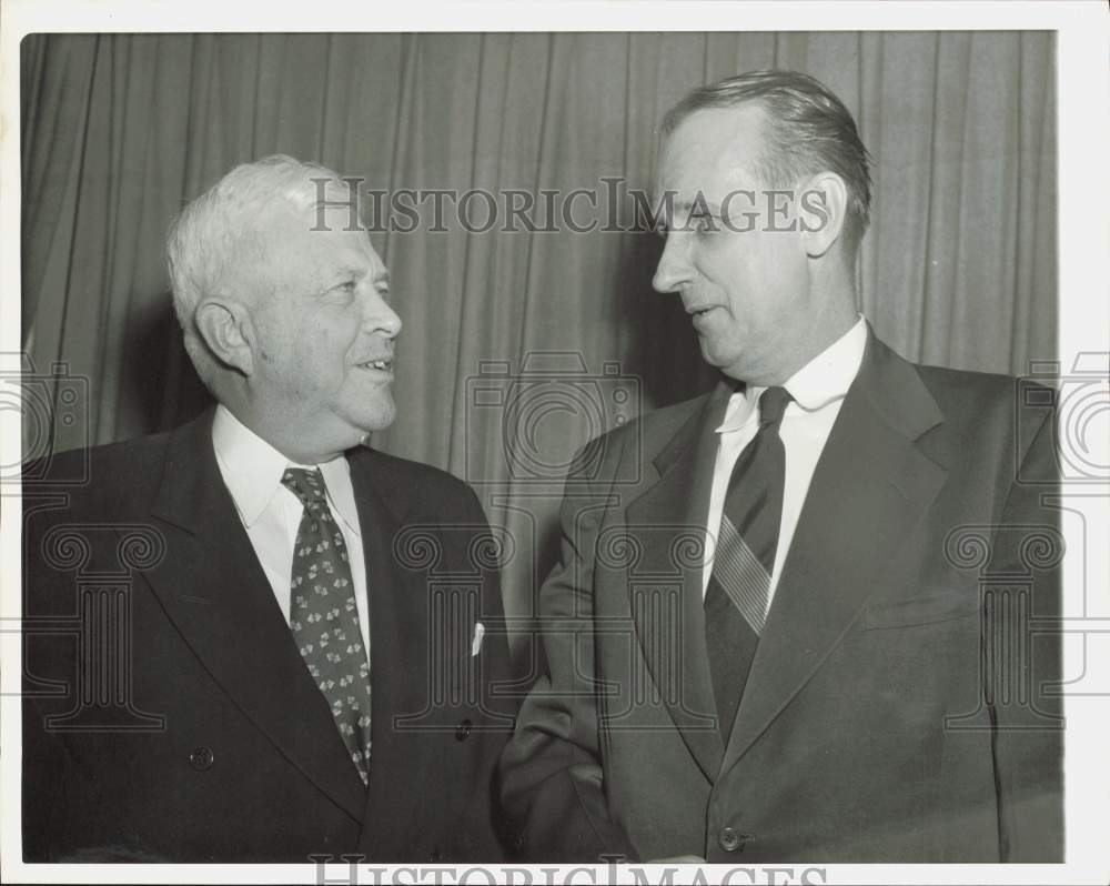 1957 Press Photo Government official C. Herschel Schooley, talks with man.- Historic Images