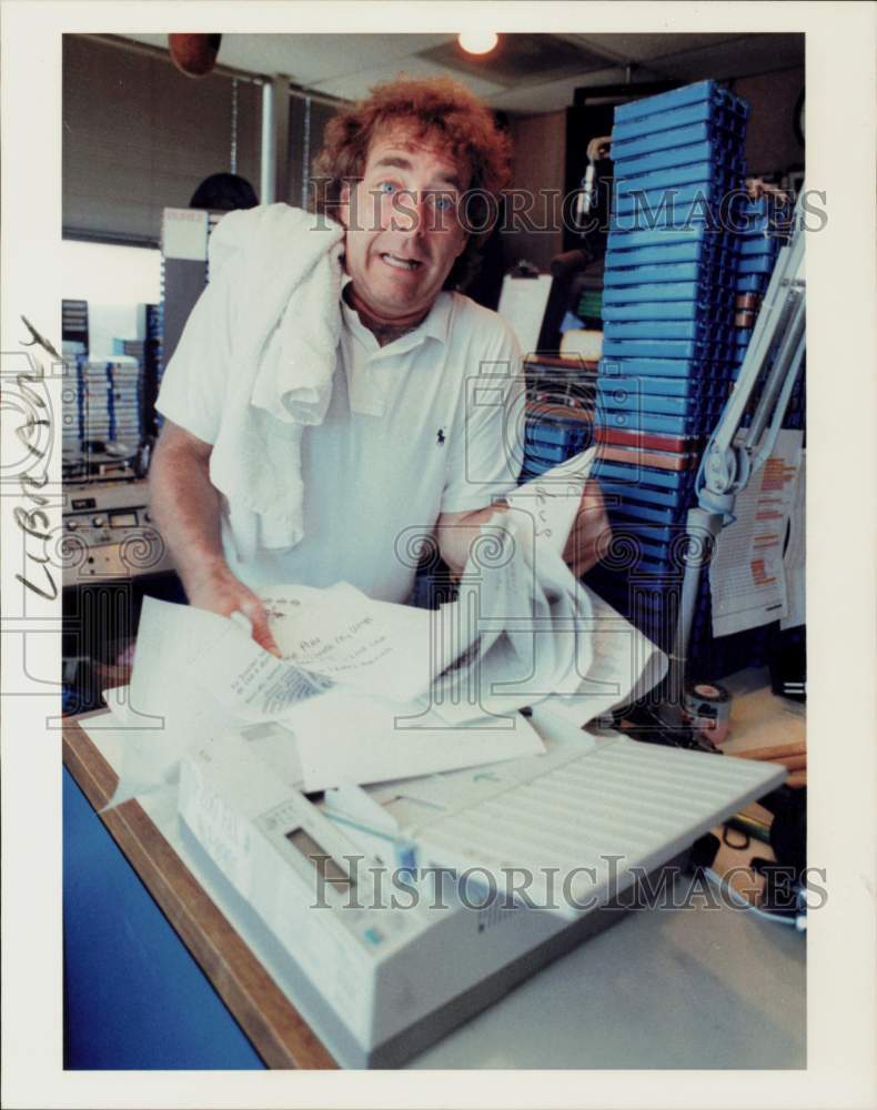 1989 Press Photo KKBQ DJ John Lander stands at fax machine used for requests- Historic Images