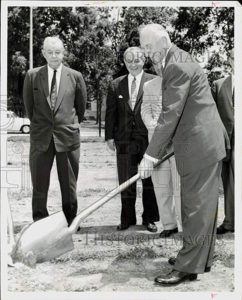 1957 Press Photo Fred Heyne digs hole at groundbreaking ceremony. - hpa95740- Historic Images