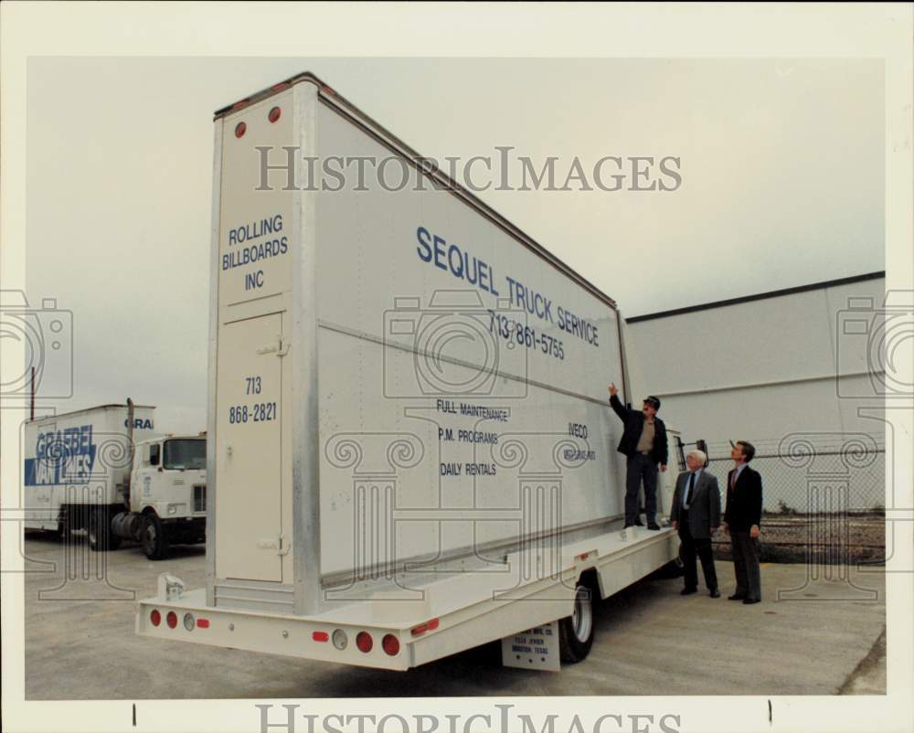 1988 Press Photo Bob Geiger, Michael Ordener, Bob Harke view Sequel Truck sign.- Historic Images