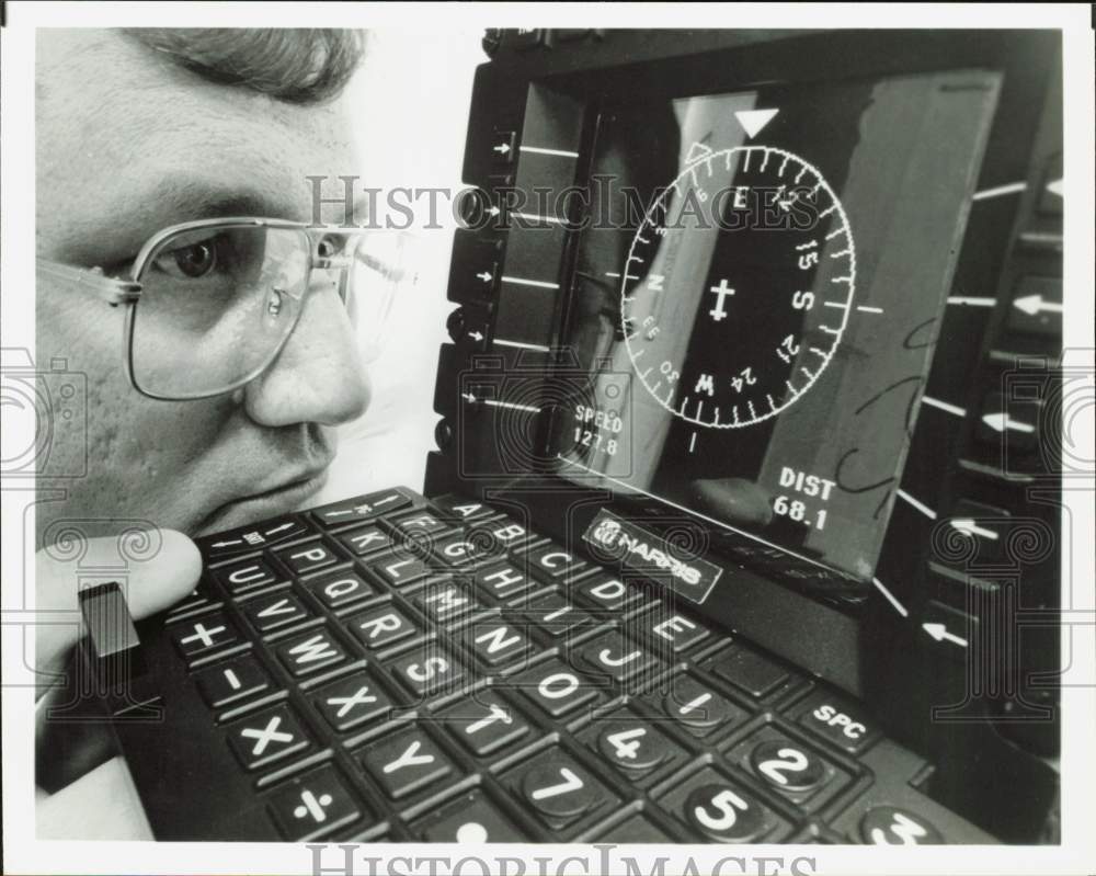 1991 Press Photo Man operates airplane equipment using a computer - hpa98614- Historic Images