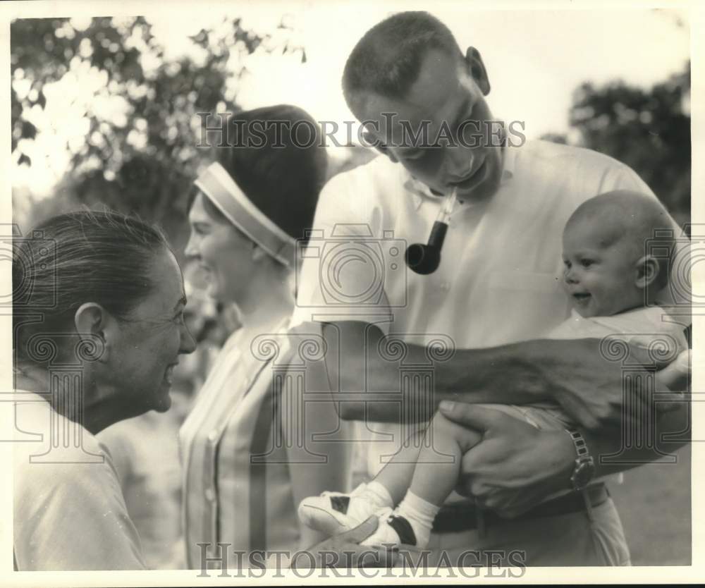 1962 Press Photo Mrs. Bob Smith smiles at Bob Bruce&#39;s baby at barbecue party- Historic Images