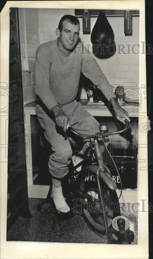 Press Photo Boxing athlete trains on stationary bike. - hps01657 - Historic Images