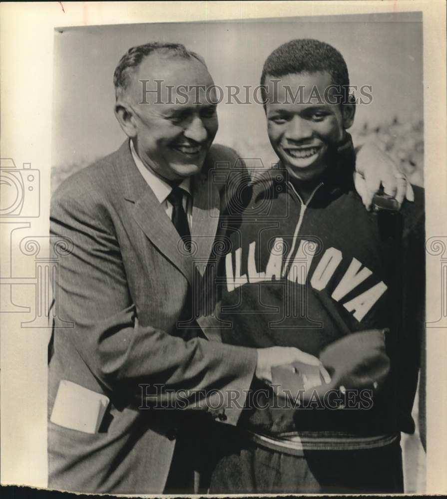 1961 Press Photo Villanova track star Frank Budd embraced by official. - Historic Images