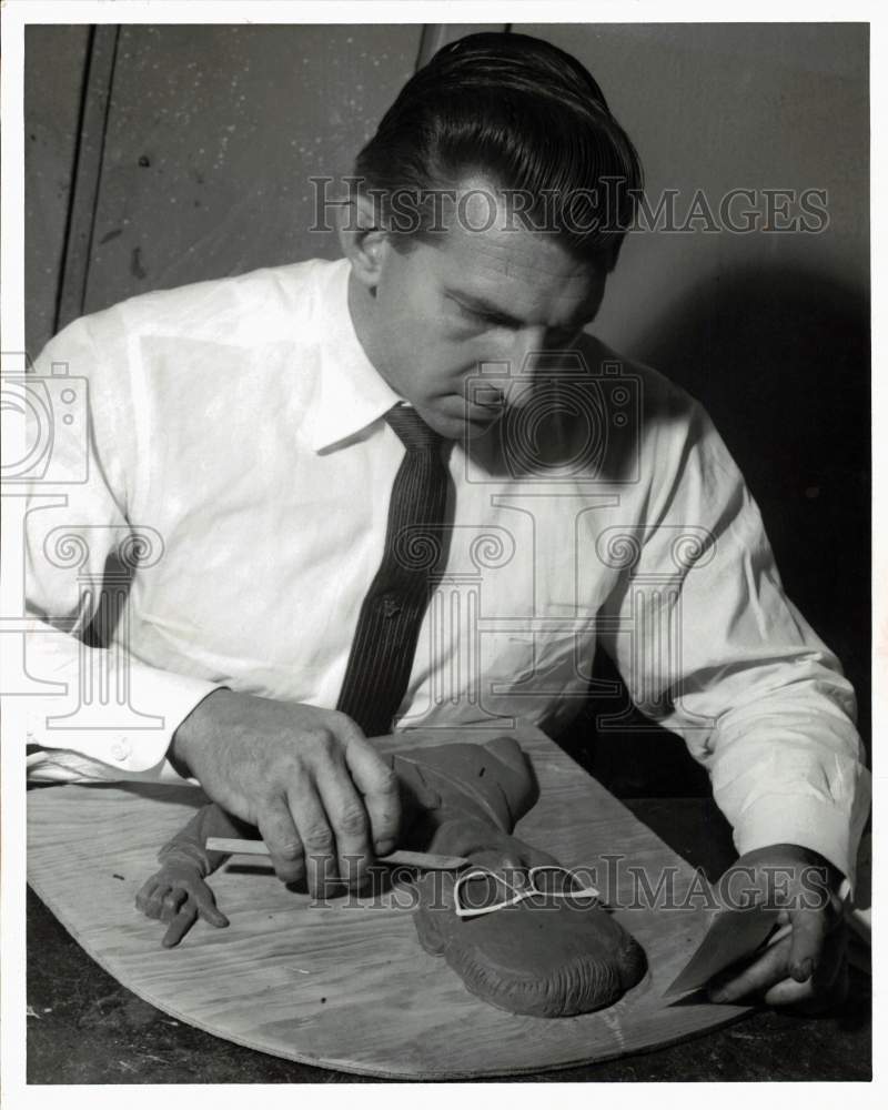 1963 Press Photo Papier mache artist William Wiese finishes his work. - Historic Images