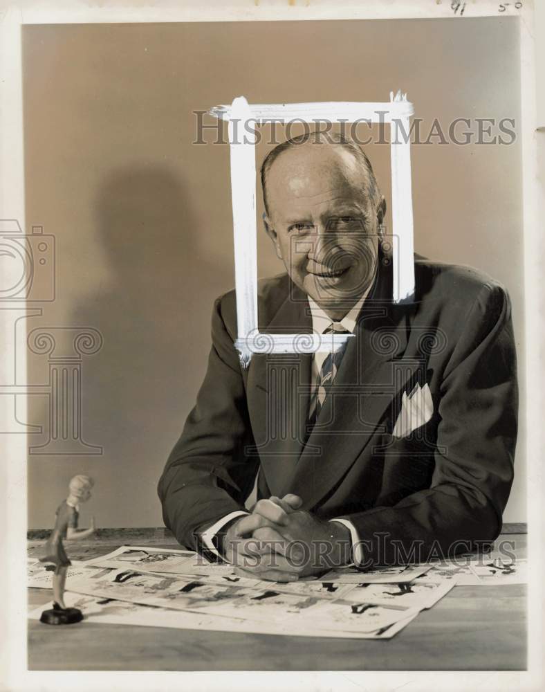 Press Photo Chic Young sitting at a desk with cartoon clips in front of him- Historic Images