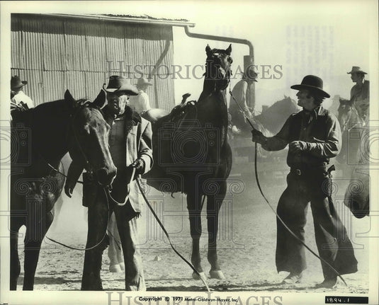 1971 William Holden, Ryan O'Neal in a scene from "Wild Rovers" - Historic Images