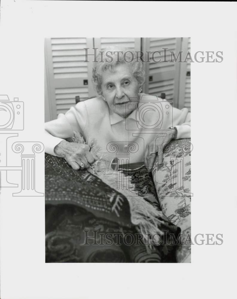 1994 Press Photo An elderly woman displays several carpets - lra11682- Historic Images