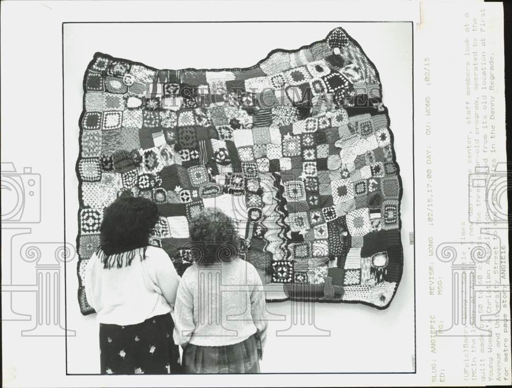 1990 Press Photo Staff members look at a quilt at Angeline&#39;s refuge center- Historic Images