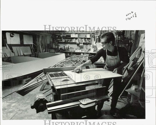 1988 Press Photo Brad Rice cutting plywood for outboard motor well in boat, AK- Historic Images