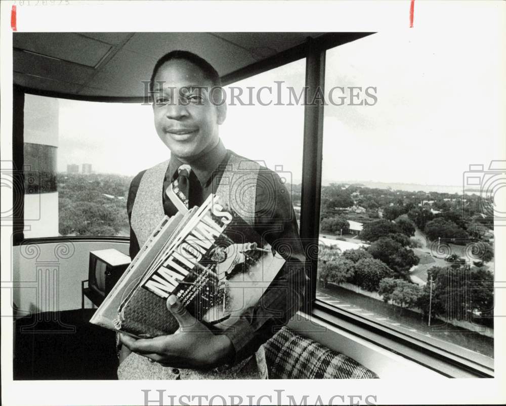 1984 Press Photo Greg Wright with &quot;Nationals&quot; magazine at his office, Florida- Historic Images