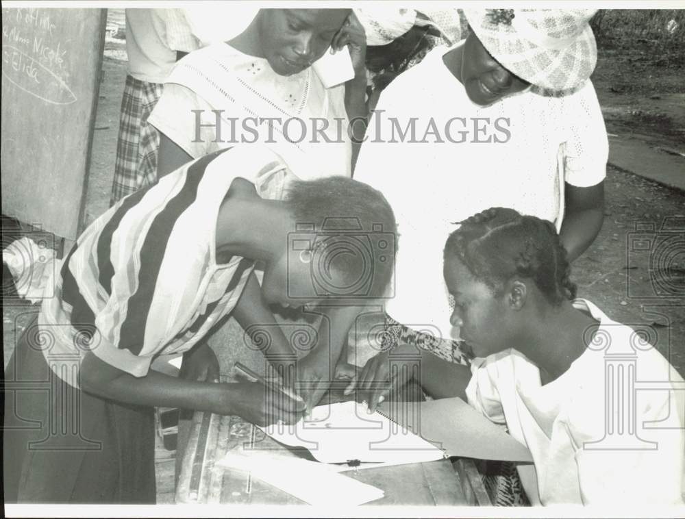 1990 Press Photo Women signing loan agreement at Village Bank, St. Marc, Haiti- Historic Images