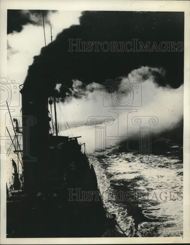 1940 Brit. destroyer throws out smoke screen to cover firing action - Historic Images