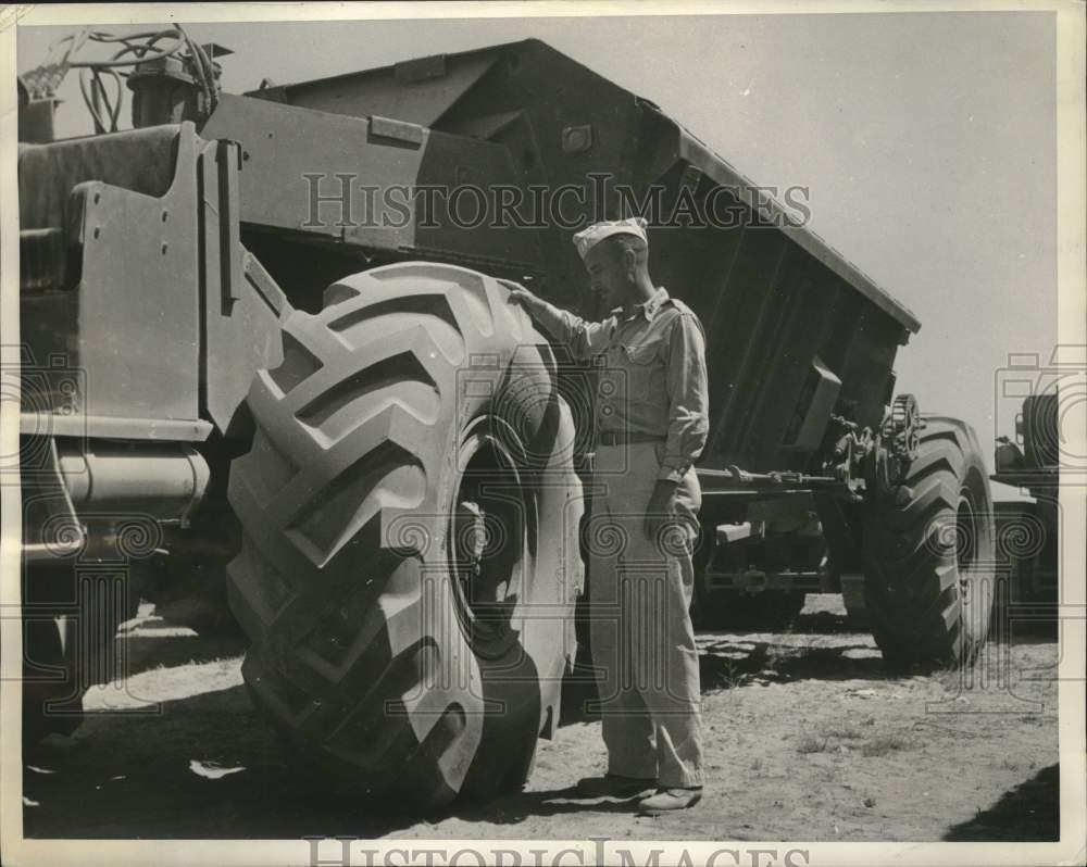 1943 N. Africa -- Capt. O'Connell examines tires of an earth carrier - Historic Images