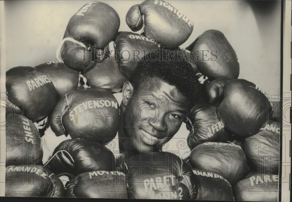 1961 Welterweight champ Emile Griffith with gloves from fights - Historic Images