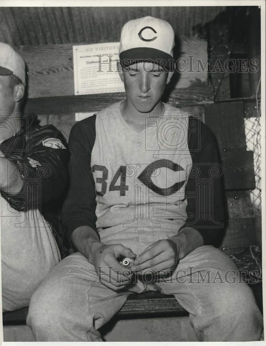1958 Claude Osteen sits in Reds dugout during Spring Training - Historic Images
