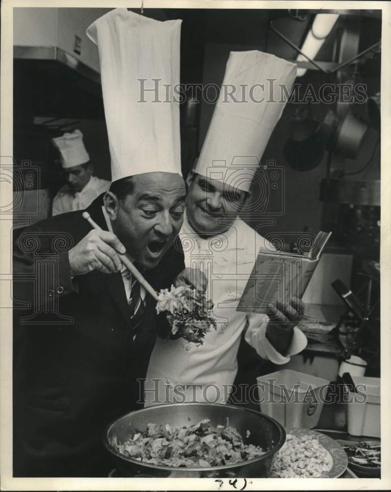 1965 Robert Merrill Tosses A Salad For John Logan At Hotel - Historic Images