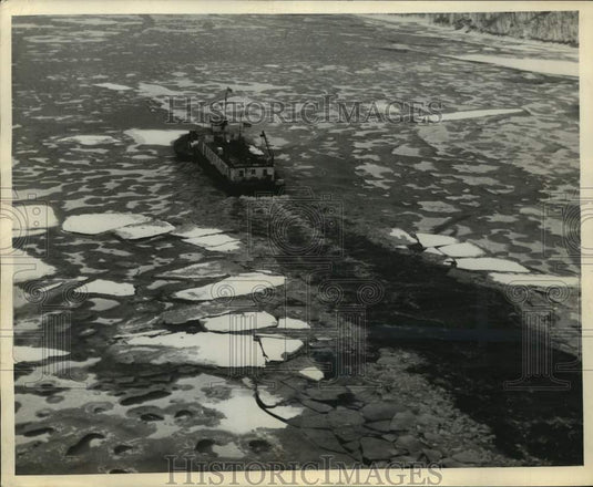 1944 Ice Breaker plows a channel in the ice above the Ford Dam - Historic Images