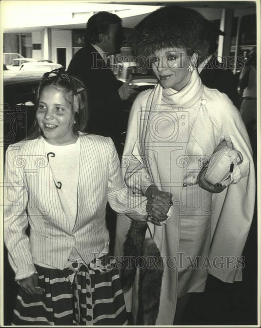 1983  Actress Joan Collins attend a Fashion Show with daughter Katy - Historic Images