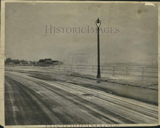 1938 Photo shows waves hitting the frozen surf at Beachmont - Historic Images