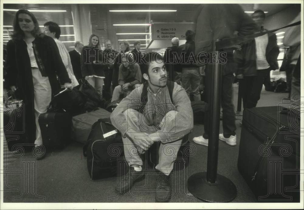 1995 Chip Swarner waits for their flights in Logan Airport - Historic Images