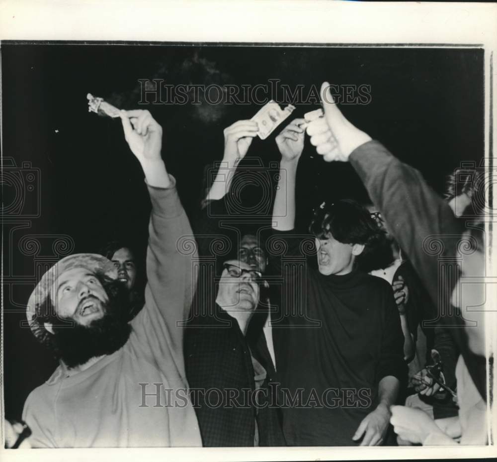 1968 Youths Burn Dollar Bills as Part of Demonstration - Historic Images