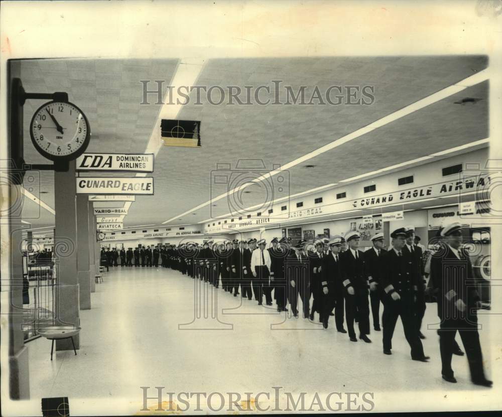 1962 Airline pilots walk through an airport terminal-Historic Images