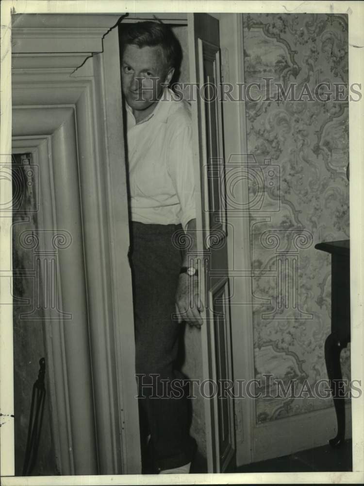 1940 Edmund Flanagan tries trap door at Governor Winslow home - Historic Images