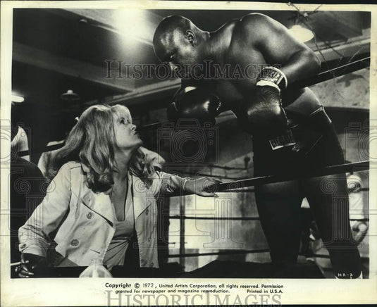 1972 Elizabeth Harding talking to Jamel Moore in a scene of "Hammer" - Historic Images