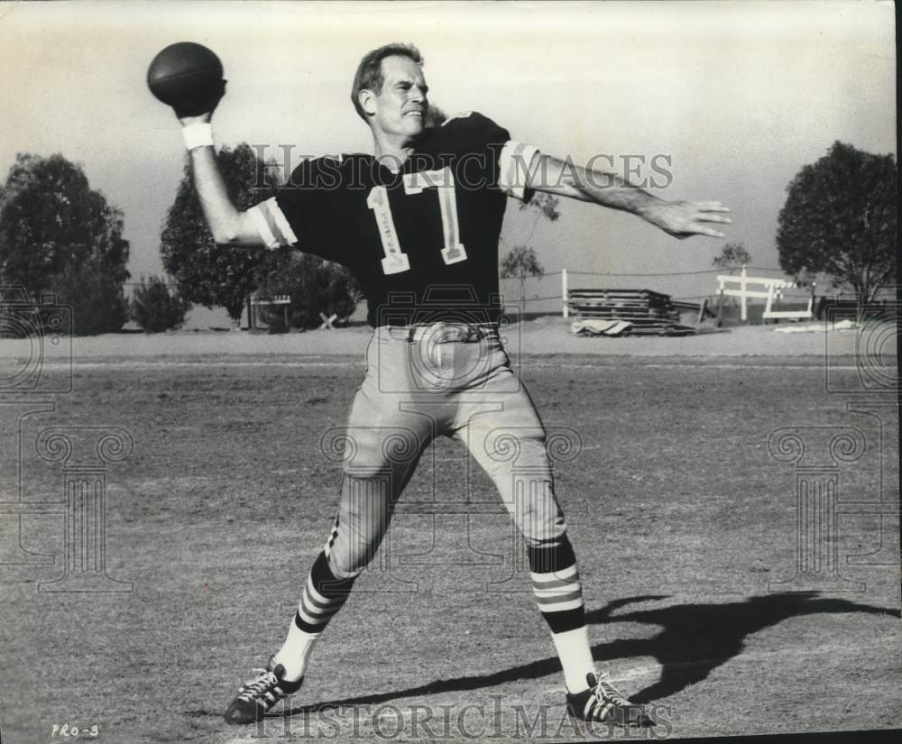 1969 American actor Charlton Heston plays football-Historic Images