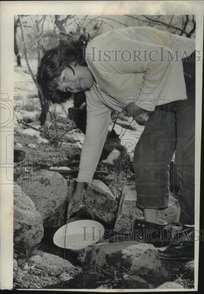 1957 An Indian woman getting water from the well at Sierra rancheria-Historic Images