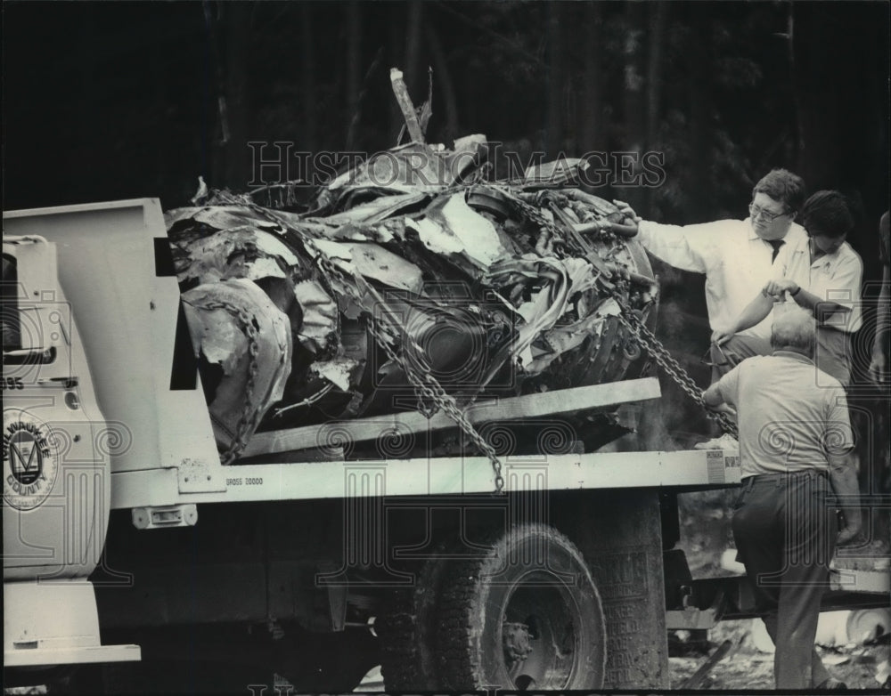 1985 Press Photo James Burnett supervises loading of wrecked Midwest DC-9 engine - Historic Images