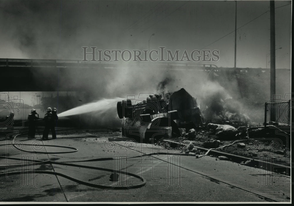 1988 Firefighters spray water on semitrailer at North-South Freeway-Historic Images