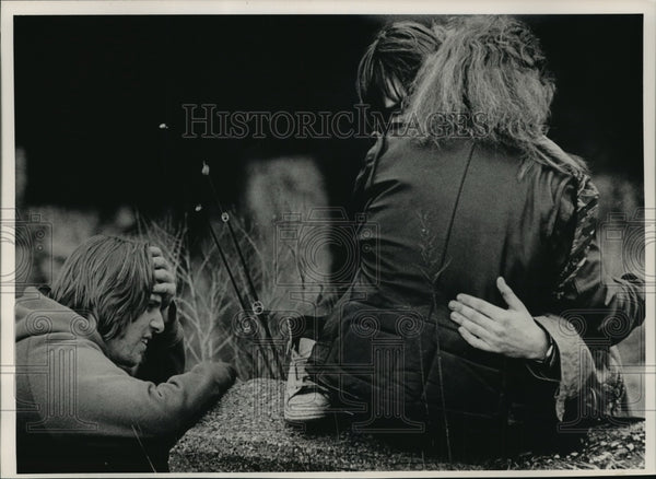 1989 Friends grieve for a man who fell to his death from a railroad ...
