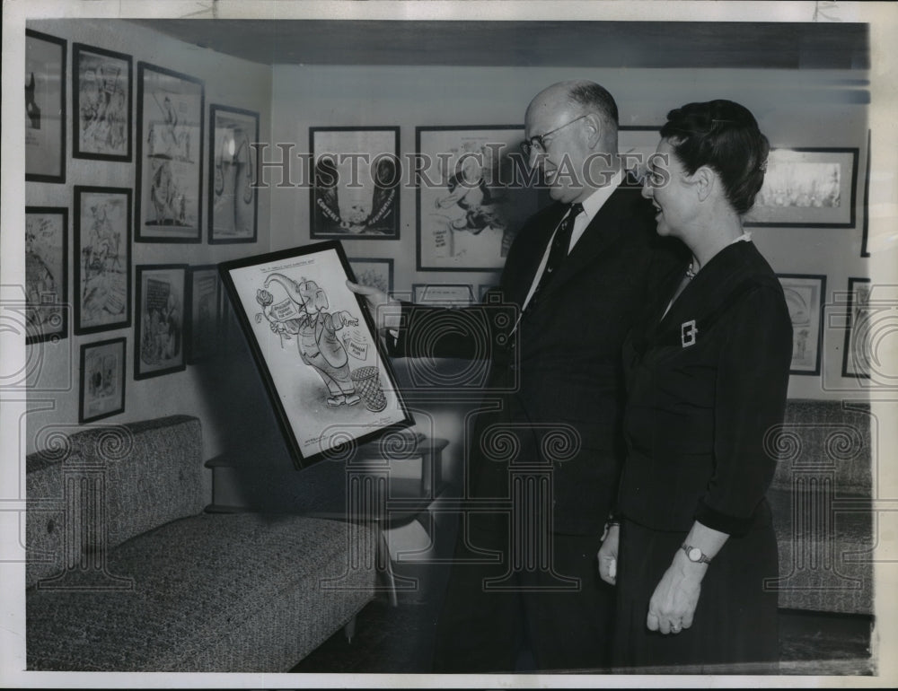 1956 Press Photo Mr. and Mrs. Charles Brannan looking at cartoons at their home - Historic Images