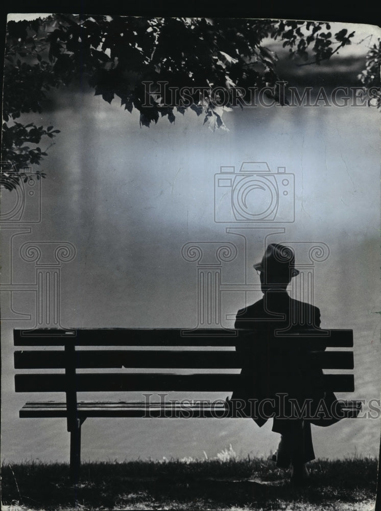 1973 Elderly Man sitting on a bench near Mitchell Park Lagoon - Historic Images